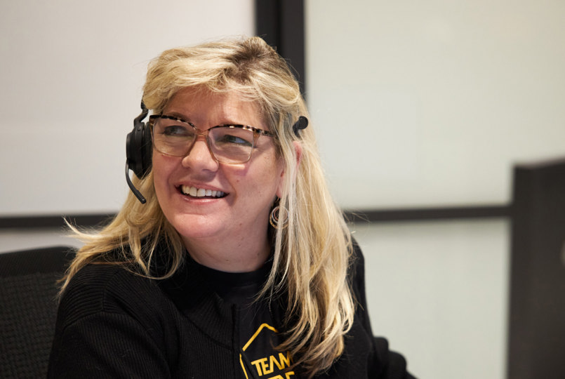 Employee smiling wearing a headset