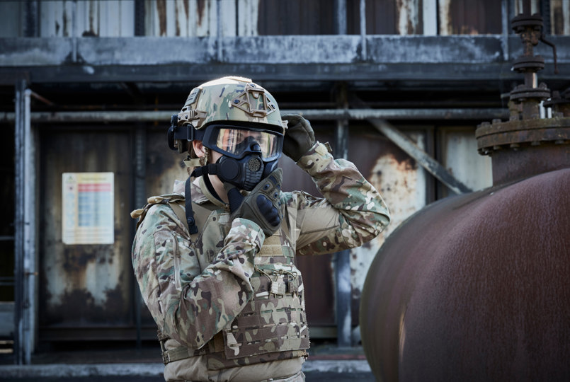 Soldier wearing a helmet and donning a respirator